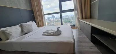 a bedroom with a white swan on a bed with a window at The Robertson Residence in bukit bintang in Kuala Lumpur
