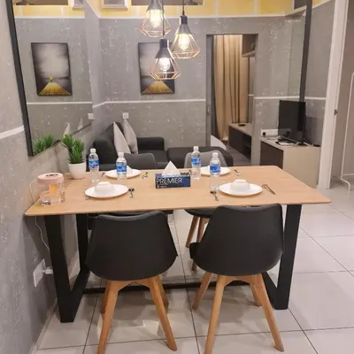 a table with two chairs and water bottles on it at The Robertson Residence in bukit bintang in Kuala Lumpur