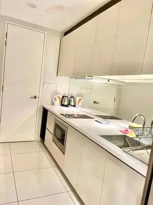 a kitchen with white cabinets and a sink at The Robertson Residence in bukit bintang in Kuala Lumpur