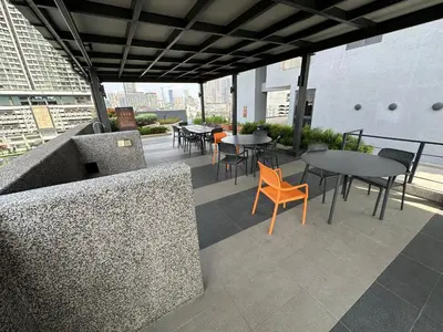 an outdoor patio with tables and chairs on a building at Sunway Velocity Two Deluxe in Kuala Lumpur