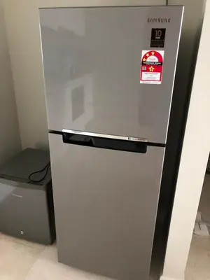 a silver refrigerator with a sticker on it at Sky Suites KLCC by Psalm Space exclusively for female travellers in Kuala Lumpur