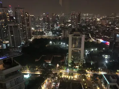 a view of a city at night with lights at Sky Suites KLCC by Psalm Space exclusively for female travellers in Kuala Lumpur
