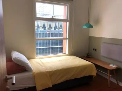 a bedroom with a bed in front of a window at Sky Suites KLCC by Psalm Space exclusively for female travellers in Kuala Lumpur