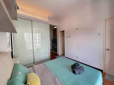 a bedroom with a bed with two pillows on it at Comfy Studio Casa Mutiara, Near LRT Hang Tuah & Lalaport in Kuala Lumpur