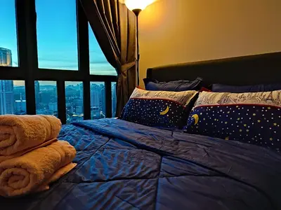 a bedroom with a bed with a view of the city at Badang Homestay KLCC in Kuala Lumpur