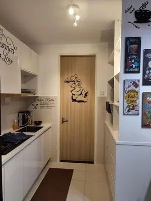 a kitchen with a door with a drawing on it at Badang Homestay KLCC in Kuala Lumpur