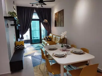 a living room with a white table and chairs at Badang Homestay KLCC in Kuala Lumpur