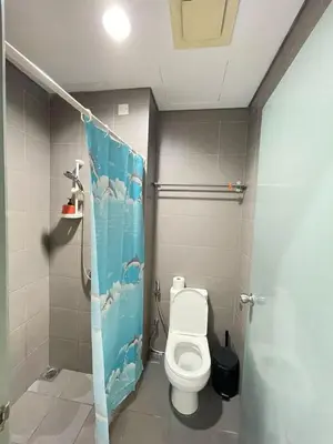 a bathroom with a toilet and a shower stall at Summer Suites Studio With Balcony Nearby KL City Centre in Kuala Lumpur