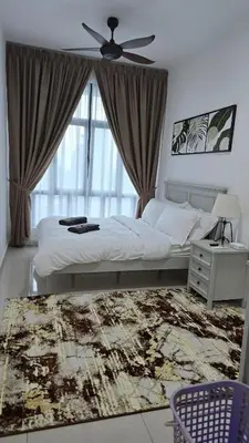 a bedroom with a bed with a ceiling fan and a window at Sophia Homestay KLCC in Kuala Lumpur