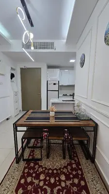 a kitchen with a wooden table in a room at Sophia Homestay KLCC in Kuala Lumpur