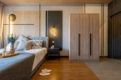 a bedroom with a blue bed and a wooden door at Modern Design 2BR Astoria in Kuala Lumpur