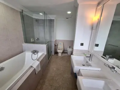 a bathroom with two sinks and a tub and a toilet at Best Apartment Suite At Times Square KL in Kuala Lumpur