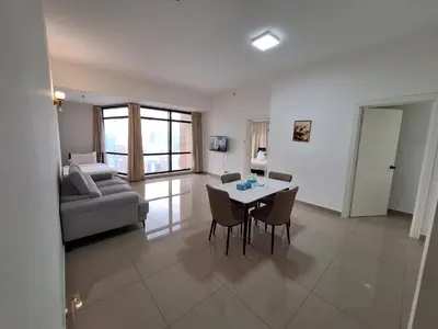 a living room with a table and a couch at Best Apartment Suite At Times Square KL in Kuala Lumpur