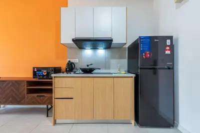 a kitchen with a black refrigerator and a stove at The Pano by Minsu in Kuala Lumpur