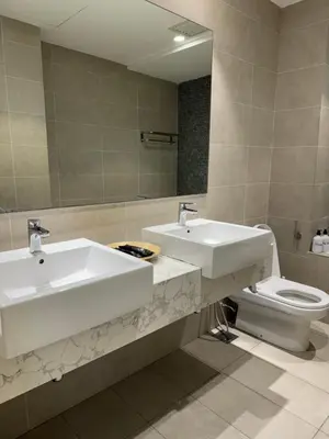 a bathroom with two sinks and a toilet at TheOoak 1BRoom cozyhome with balcony in Kuala Lumpur