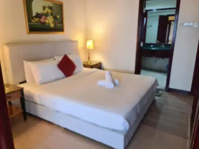 a bedroom with a large white bed in a room at Soho Service Suite at Times Square KL in Kuala Lumpur
