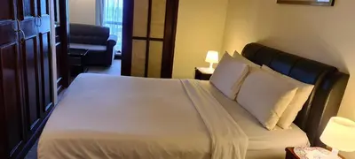 a bedroom with a large bed with white pillows at Soho Service Suite at Times Square KL in Kuala Lumpur