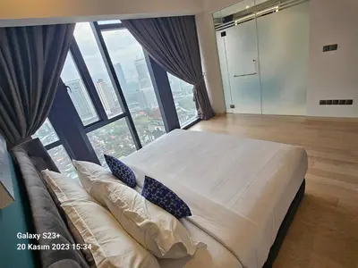 a bedroom with a large bed with a large window at Star Residence T1, 2br Unit Floor 36 in Kuala Lumpur
