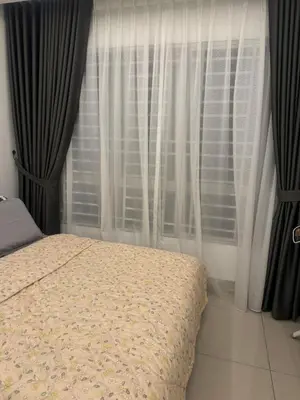 a bedroom with a bed in front of a window at Ayazuki Sky Suite KLCC View 2BR Free Parking Netflix Swimming Pool in Kuala Lumpur