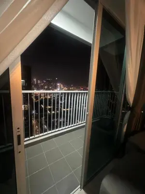 a balcony with a view of the city at night at Ayazuki Sky Suite KLCC View 2BR Free Parking Netflix Swimming Pool in Kuala Lumpur