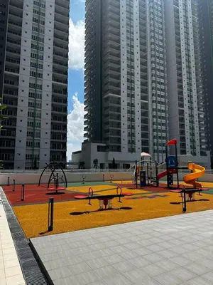a playground with benches and play equipment in front of tall buildings at Ayazuki Sky Suite KLCC View 2BR Free Parking Netflix Swimming Pool in Kuala Lumpur