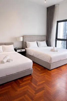 two beds sitting next to each other in a bedroom at Atmoods - The Mews KLCC in Kuala Lumpur