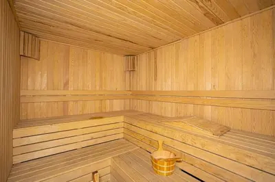 an empty wooden sauna with a bucket in it at Mid Night Realm Kuala Lumpur in Kuala Lumpur