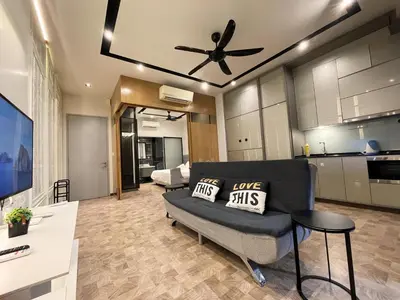 a living room with a couch and a ceiling fan at Expressionz KLCC By Sky Homez in Kuala Lumpur