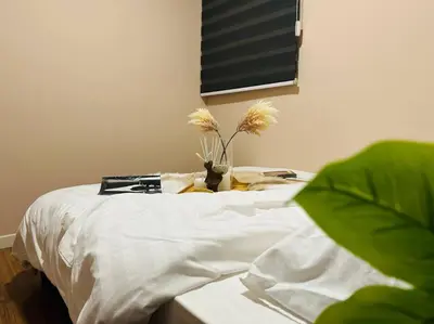 a bed with white sheets and a vase with flowers on it at MVA17#Family Suite 8pax 3 Rooms M Vertica Velocity Mall Cheras IKEA Mytown Short Walk to MRT & LRT Maluri in Kuala Lumpur