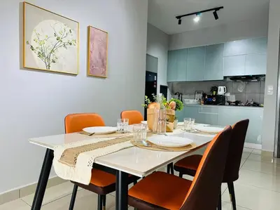 a dining room with a table with orange chairs at MVA17#Family Suite 8pax 3 Rooms M Vertica Velocity Mall Cheras IKEA Mytown Short Walk to MRT & LRT Maluri in Kuala Lumpur