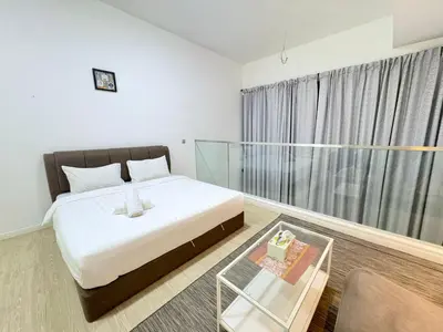 a bedroom with a bed and a glass table at Mcity Residence way to KLCC in Kuala Lumpur