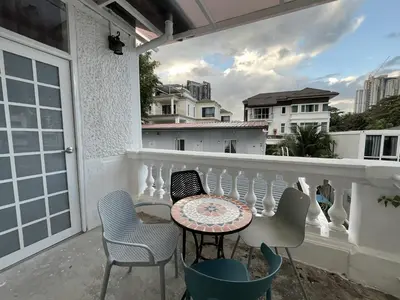 a patio with a table and chairs on a balcony at Titiwangsa Premium Villa KL by uBook in Kuala Lumpur