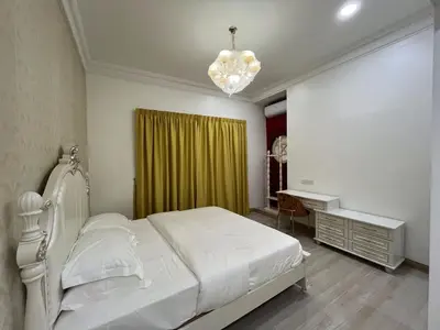 a bedroom with a white bed and a desk at Titiwangsa Premium Villa KL by uBook in Kuala Lumpur