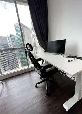 a desk with a computer in a room with a window at Binjai 8 Soho Premium Near KLCC & LRT KLCC in Kuala Lumpur