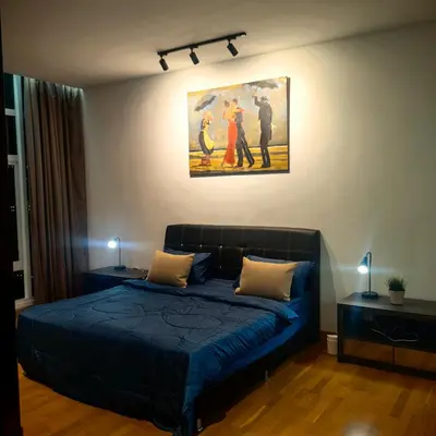 a bedroom with a blue bed and a painting on the wall at KL Sentral Dua Sentral Cozy Homestay Apartments by Hollywood Homes #FreeCarPark in Kuala Lumpur