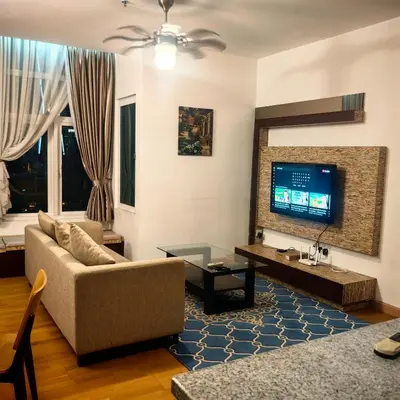 a living room with a couch and a tv at KL Sentral Dua Sentral Cozy Homestay Apartments by Hollywood Homes #FreeCarPark in Kuala Lumpur