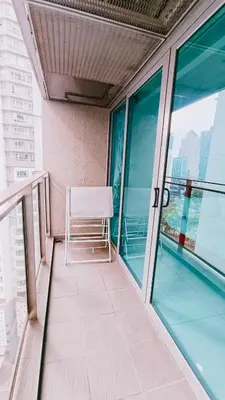 a chair sitting on the balcony of a building at Summer Suites KLCC By CityHomes in Kuala Lumpur