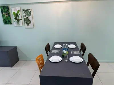 a dining room with a black table and chairs at Summer Suites KLCC By CityHomes in Kuala Lumpur