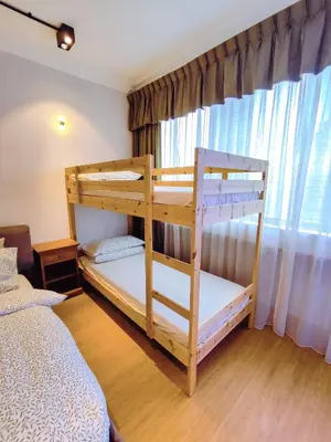 a bedroom with two bunk beds and a window at Bukit Bintang Pavilion KLCC Wisma Cosway in Kuala Lumpur