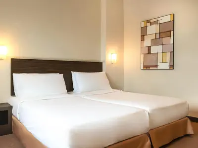 a large white bed in a hotel room at Hotel Summer View in Kuala Lumpur