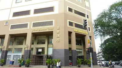 a building on a street with people walking in front of it at Hotel Summer View in Kuala Lumpur