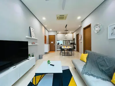 a living room with a couch and a table at Soho Suites KLCC by DeUrban in Kuala Lumpur
