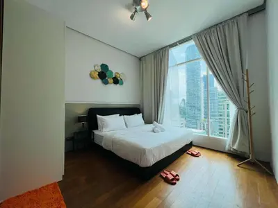 a bedroom with a bed and a large window at Soho Suites KLCC by DeUrban in Kuala Lumpur