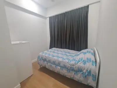 a small bedroom with a bed and a window at Muji Themed Apartment by Zen Sojourn - Opposite KL SENTRAL in Kuala Lumpur