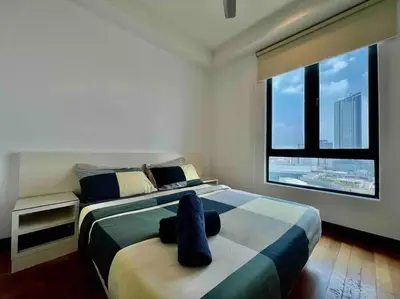 a bedroom with two beds and a large window at Couple Suite at Casa Residency 5 mins walk to LRT, Jalan Alor & Bukit Bintang in Kuala Lumpur