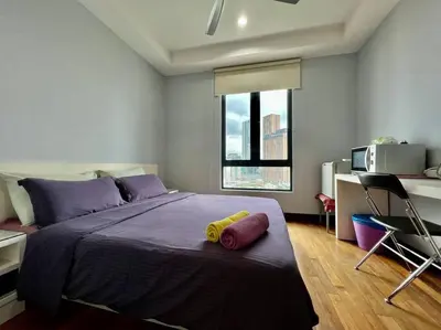 a bedroom with a bed with a yellow object on it at Couple Suite at Casa Residency 5 mins walk to LRT, Jalan Alor & Bukit Bintang in Kuala Lumpur