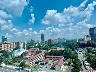 a city with tall buildings and a blue sky with clouds at Couple Suite at Casa Residency 5 mins walk to LRT, Jalan Alor & Bukit Bintang in Kuala Lumpur