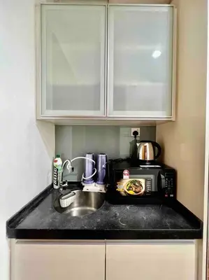 a kitchen counter with a sink and a microwave at Couple Suite at Casa Residency 5 mins walk to LRT, Jalan Alor & Bukit Bintang in Kuala Lumpur
