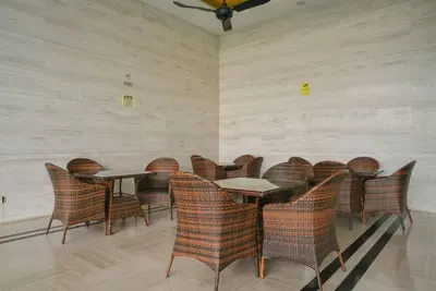 a dining room with wicker chairs and tables at Couple Suite at Casa Residency 5 mins walk to LRT, Jalan Alor & Bukit Bintang in Kuala Lumpur