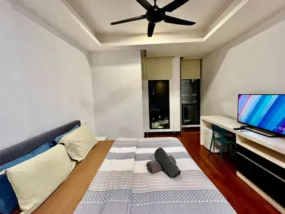 a bedroom with a bed with a ceiling fan at Couple Suite at Casa Residency 5 mins walk to LRT, Jalan Alor & Bukit Bintang in Kuala Lumpur